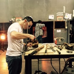 Orbix Hot Glass - Staff placing finishing touches on ornament before placing in kiln.