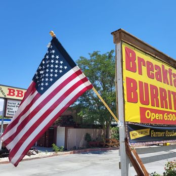 Hugo’s BBQ - a large american flag in front of a restaurant - Barbeque Near Me - Big Pine, California