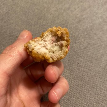 Buffalo Wild Wings - a hand holding a piece of food - Sports Bars Near Me - Tyler, Texas