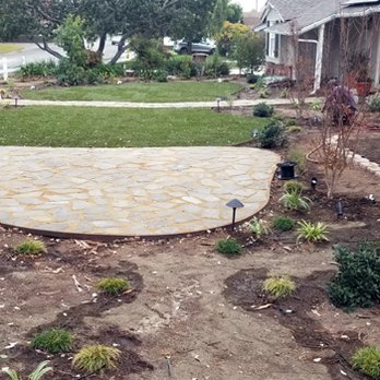 Green Grass Landscaping - Flagstone area for seating or fire pit - Landscaping Near Me