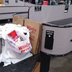 WinCo Foods - Conveyor belt right next to the Paper and plastic bags. This really helps w bagging groceries.