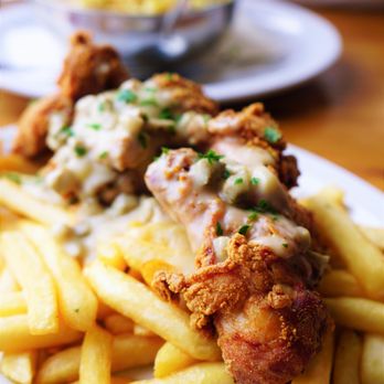 Milkweed - Buttermilk Fried Chicken with Chicken Sausage Bourbon Gravy & French Fries - New American Near Me - Boston, Massachusetts Milkweed - Buttermilk Fried Chicken with Chicken Sausage Bourbon Gravy & French Fries - New American Near Me - Boston, Massachusetts