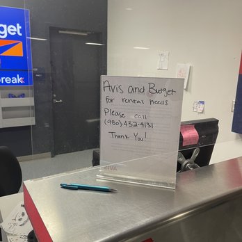 Avis Rent A Car - Empty Service Counter and Sign to call service support that isn't on-site and tells you there are no vehicles available. - Car Rental Near Me - Concord, North Carolina