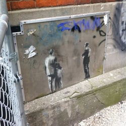 Banksy tiny tag - The building next to it is under construction so the alley is blocked off, but it's right on the corner so it's accessible.