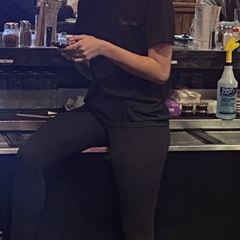 Santarpio's Pizza - This is the bartender hard at work and SITTING on the beverage cooler! - Pizza Near Me - Peabody, Massachusetts Santarpio's Pizza - This is the bartender hard at work and SITTING on the beverage cooler! - Pizza Near Me - Peabody, Massachusetts