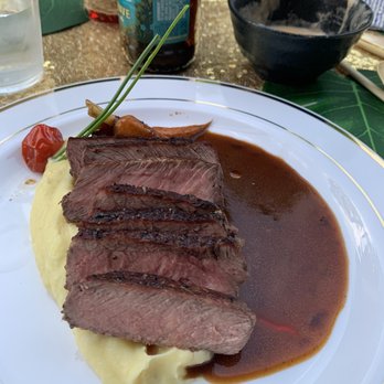 Zach’s Event Catering - NY steak served over a potato purée with a beef and soy reduction and a blistered tomato - Caterers Near Me Zach’s Event Catering - NY steak served over a potato purée with a beef and soy reduction and a blistered tomato - Caterers Near Me