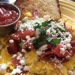 Scramble w/bacon. Greek feel but with a side of salsa. This is a lunch sized plate to give you an idea on portion size.