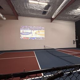 Indoor pickleball area with TV