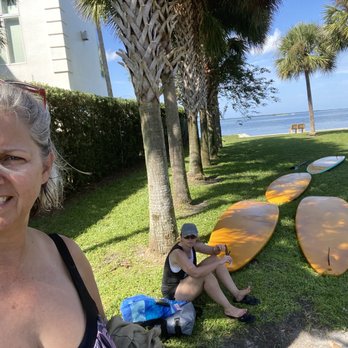 Floating Lotus SUP - Helping to bring up the boards. - Yoga Near Me Floating Lotus SUP - Helping to bring up the boards. - Yoga Near Me