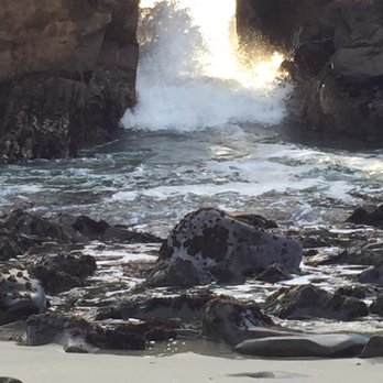 Pfeiffer Beach - Waves crashing through the keyhole arch at Pfeiffer Beach - Beaches Near Me - Big Sur, California