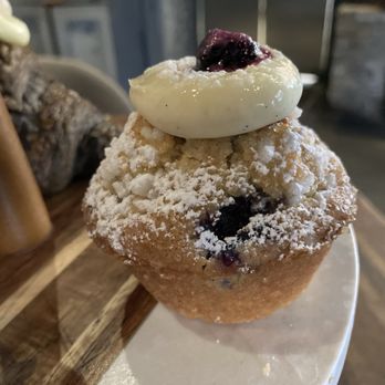 S.K.Y. - Blueberry butter muffin -- olive oil, sweet cream, blueberries, sugary powder - New American Near Me - Chicago, Illinois S.K.Y. - Blueberry butter muffin -- olive oil, sweet cream, blueberries, sugary powder - New American Near Me - Chicago, Illinois