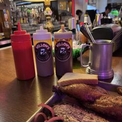 Ketchup on the left, middle bottle is mustard style sauce and the one on the right is regular bbq sauce.