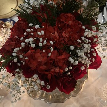 Chef Adrianne's Vineyard Restaurant and Bar - Elegant centerpiece featuring Red Roses and red-dyed Hydrangeas, accented by Winter Greens and Baby's Breath - Steakhouses Near Me - Miami, Florida