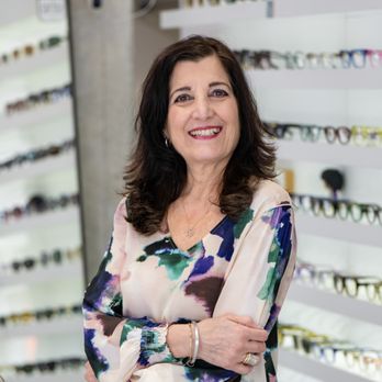 Specs & Spines Optometry and Chiropractic - Rosanna standing in front of a wall of eyeglasses inside Specs & Spines Optometry in Toronto. - Eyewear & Opticians Near Me - Toronto, Ontario Specs & Spines Optometry and Chiropractic - Rosanna standing in front of a wall of eyeglasses inside Specs & Spines Optometry in Toronto. - Eyewear & Opticians Near Me - Toronto, Ontario