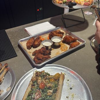 The First Amendment a Pizza Joint - Chicken pesto sandwich, wings, and hot Hawaiian pizza. We already ate half of everything. So delicious! - Pizza Near Me - Claremont, California