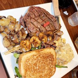 3 Knocks Speakeasy - Ribeye, green beans, potatoes, shrimp, brisket Mac and cheese.