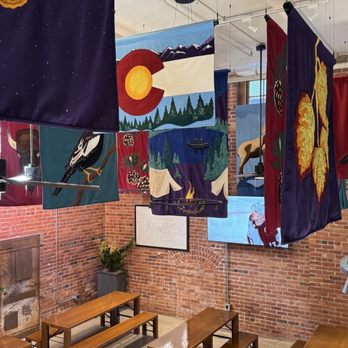 Schoolyard Cafe - Lightfilled seating with decorative flags at the adjacent bar - Ice Cream & Frozen Yogurt Near Me - Denver, Colorado