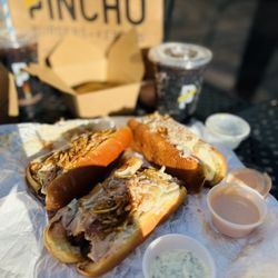 PINCHO - Pincho dog! Topped with applewood-smoked , pinnaple bits, cilantro, pickles, onions, crispy fries, fresh brioche bread