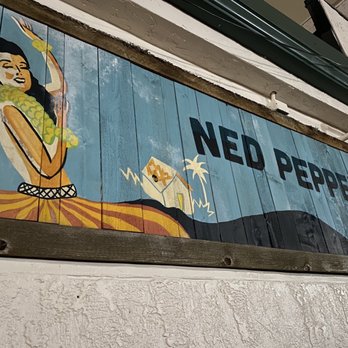 Ned Peppers Bar - a woman on a surfboard - Tiki Bars Near Me - Dayton, Ohio Ned Peppers Bar - a woman on a surfboard - Tiki Bars Near Me - Dayton, Ohio