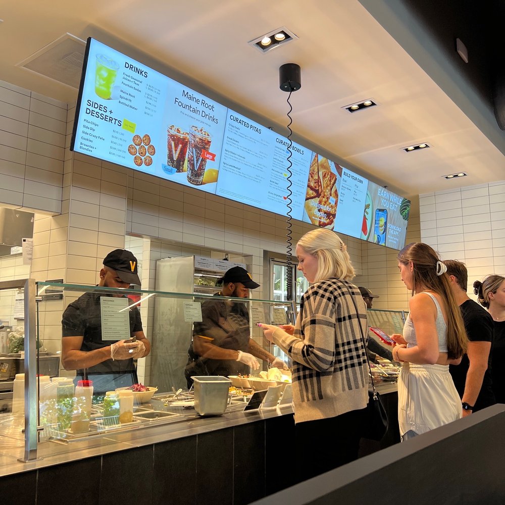 CAVA - a group of people ordering food at a restaurant - Salad Near Me - Nashville, Tennessee