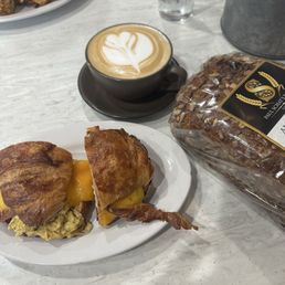 Breakfast sandwich, latte, bread Breakfast sandwich, latte, bread