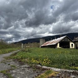 Northern State Recreation Area - View from the end of the semi-paved uphill path with asylum buildings, mountains, and wildflowers