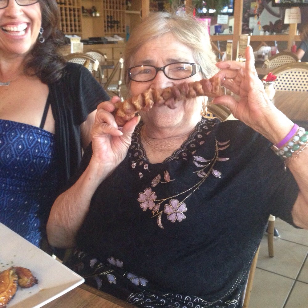 Mi Pueblo - Abuela enjoying a chicharron - Colombian Near Me - Miami, Florida Mi Pueblo - Abuela enjoying a chicharron - Colombian Near Me - Miami, Florida