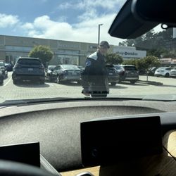 Gellert Marketplace - Security Parking Scam! Racist tries to tow, blocks car with his body and "you people" need to open eyes because I'm Asian.