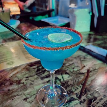 Mangos Kitchen Bar - a blue margarita with a lime slice - Mexican Near Me - Vancouver, British Columbia