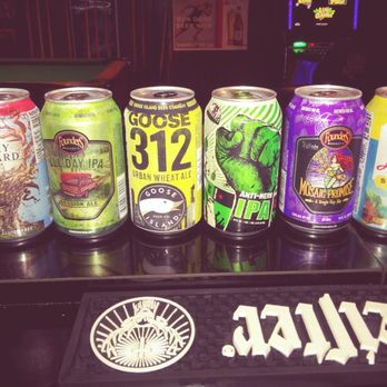 Drift Inn - a row of beer cans on a bar - Dive Bars Near Me - Gilberts, Illinois