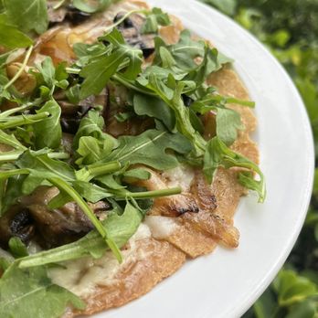 My Organic Corner - Caramelized onions & cremini on a toasted gluten-free warp with garlic, vegan mozzarella cheese , & arugula. - Vegetarian Near Me - Weston, Florida My Organic Corner - Caramelized onions & cremini on a toasted gluten-free warp with garlic, vegan mozzarella cheese , & arugula. - Vegetarian Near Me - Weston, Florida