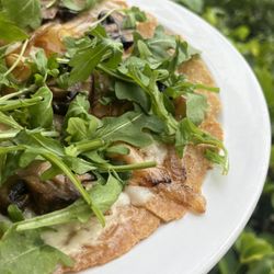 My Organic Corner - Caramelized onions & cremini on a toasted gluten-free warp with garlic, vegan mozzarella cheese , & arugula.