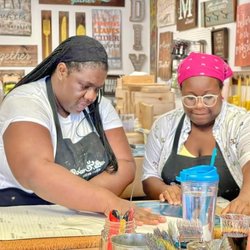 Board & Brush Charleston - Hard at work pulling the transfer paper off after detailed instructions.
