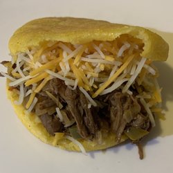 Canaima Venezuelan Delights - Fresh handmade gluten free arepa stuffed with shredded beef, mix cheese, and topped with our canaima sauce!