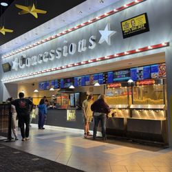 AmStar Cinemas Lake Mary - Concession stand with self serve popcorn and butter dispensers.