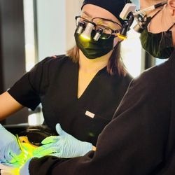 Cedar Park Dental Wellness - Precision teamwork! Dr. Regina and Iulia, donning dental loupes and focused light, work their magic on a comfy patient. ‍‍