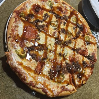 Voodoo Brewing - a pepperoni pizza on a table - Brewpubs Near Me - Katy, Texas