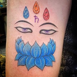 Blue lotus with the Buddha Eyes of truth tattoo. Blue lotus with the Buddha Eyes of truth tattoo.