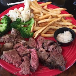 8 oz. prime rib with vegetables and fries.