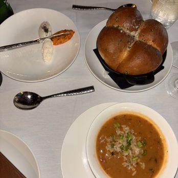 Rainbow Lodge - The Lodge's Smoked Duck Gumbo Four Warm Lodge Rolls Served In Cast Iron - New American Near Me - Houston, Texas