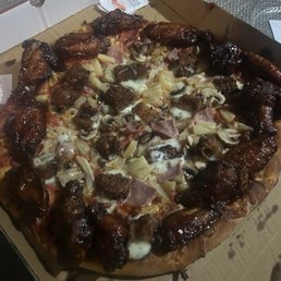 The pizza with all the toppings, including the 14 wings around the edge of the pie. The pizza with all the toppings, including the 14 wings around the edge of the pie.