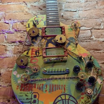 The Haven - a guitar with a lot of stickers on it - Music Venues Near Me - Pomona, California