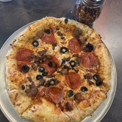 Pie Five Pizza - Stuffed crust with pepperoni sausage and olives. Taken next to shaker for size reference