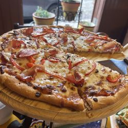 Cafe Napoles - Medium Napolitana pizza. Really fresh ingredients. Overly crisp crust, would consider it a think crust pie.