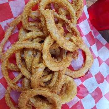 JT's Cafe - Onion rings side - A serving of crispy, breaded onion rings on checkered paper, likely from a casual restaurant or diner. - Breakfast & Brunch Near Me - Blue Point, New York