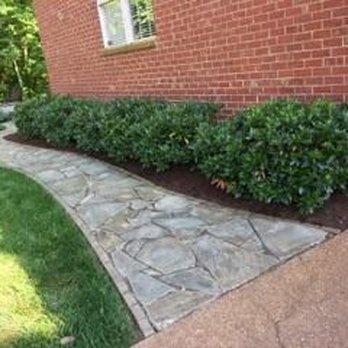 Top Hill Landscaping - a brick house with a stone walkway - Landscaping Near Me - Franklin, Tennessee
