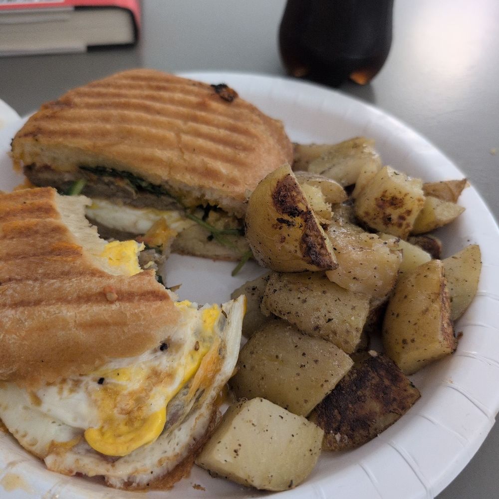 Breakfast panini with sausage, cheddar, spinach, and tomato. Breakfast panini with sausage, cheddar, spinach, and tomato.