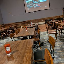 Dogwood Social House - Back seating area with a big screen and corn hole