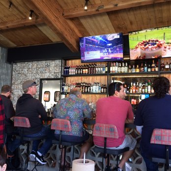 The Crack Shack - The bar area with a great view of those luscious chickens in their natural habitat above the bottles. - New American Near Me - Encinitas, California