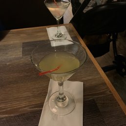 a glass of cocktail on a table a glass of cocktail on a table